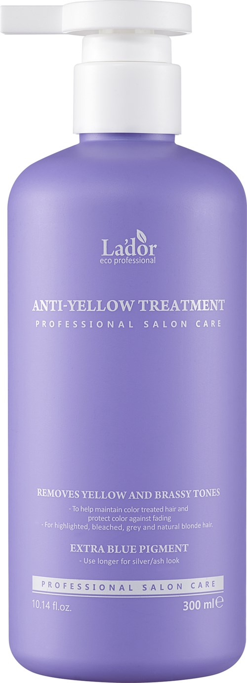 Een paarse fles met een witte pomp met label 'Lador anti-yellow treatment' voor haarverzorging.