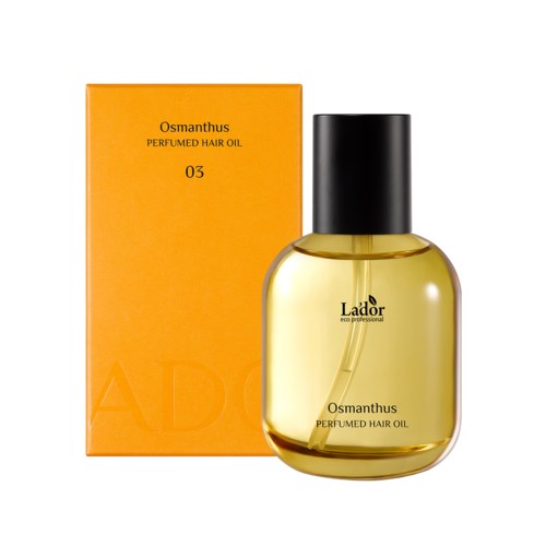 Flesje geparfumeerde haarolie naast een oranje doos met Osmanthus, met zwarte dop en gele vloeistof.