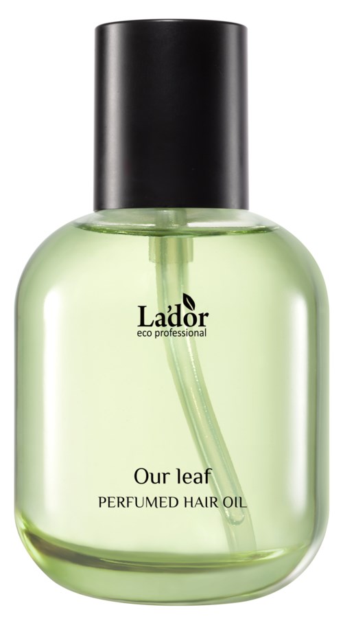 A clear green bottle with black cap, labeled 'Our leaf Perfumed Hair Oil' by Lador, contains liquid and a pour spout.
