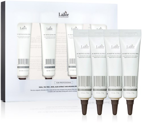 Set van zes witte tubes met zwarte doppen, gemarkeerd voor hoofdhuidverzorging, op een witte achtergrond.
