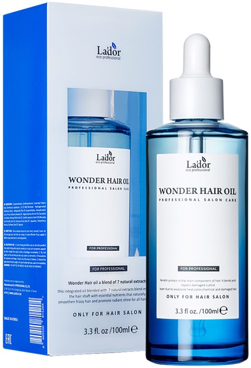 Een blauw-witte doos en fles Wonder Hair Oil voor professioneel gebruik, met druppelkoker.