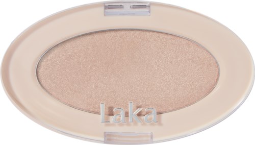 A beige eyeshadow with a shiny finish in an oval compact labeled 'Laka'.