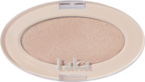 A beige oval makeup compact with eyeshadow and the word "Laka" on it.