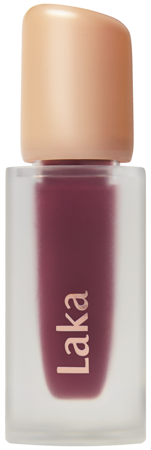 Kleine fles met donkerroze of rode lippenstift met beige dop, gemarkeerd "Laka".