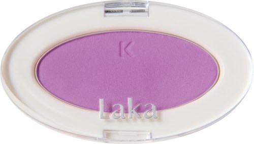 A purple eyeshadow inside a white oval case with a transparent lid. The case has the word "Laka" and a 'K' on it.
