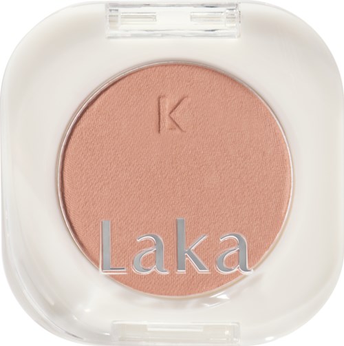 Pink blush in a white round case with a clear lid, marked with a 'K' and 'Laka' on it.