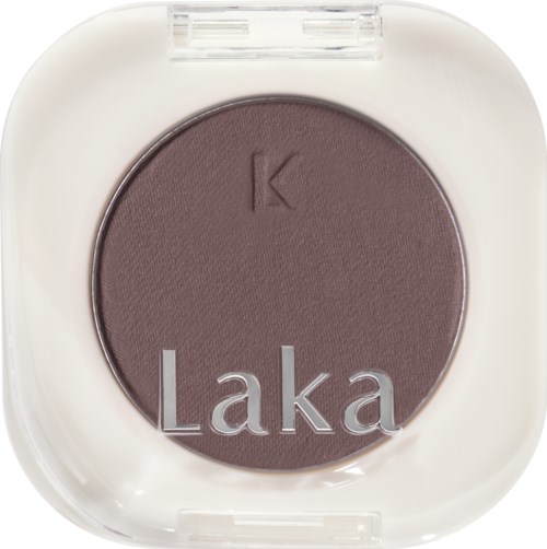 A purple eyeshadow in a white square case with the words "K Laka" on the surface.
