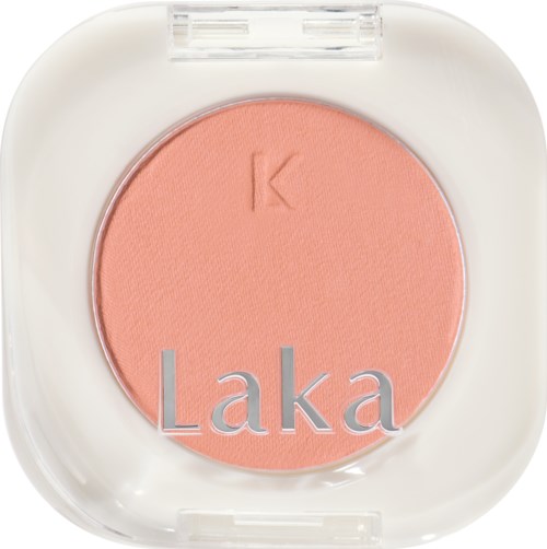 A pink blush compact with the brand name 'Laka' and the letter 'K' embossed inside.