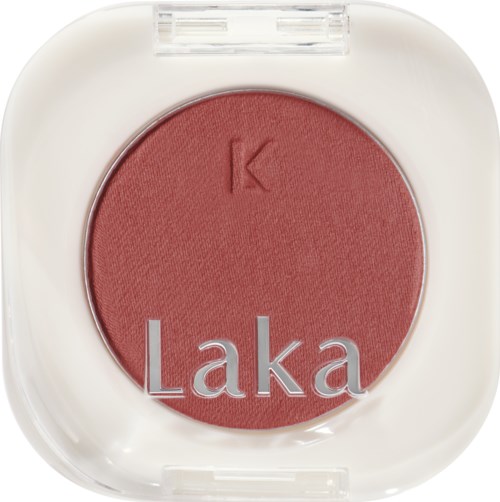 A round blush compact with a letter 'K' and the word 'Laka' on it.
