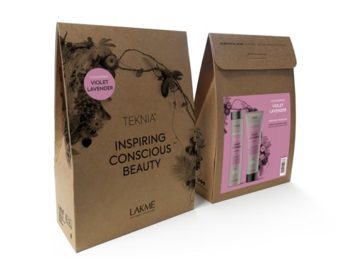 Brown gift box with a pink label and natural decorations, containing pink skincare products and a brochure.