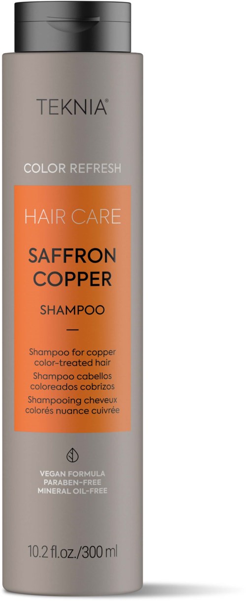 A tall grey shampoo bottle with orange label, black cap, and text detailing hair care ingredients and benefits.