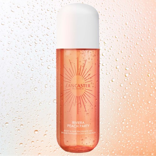 A peach-colored spray bottle with white cap, labeled Lancaster Rivera Peach Party, surrounded by water droplets.