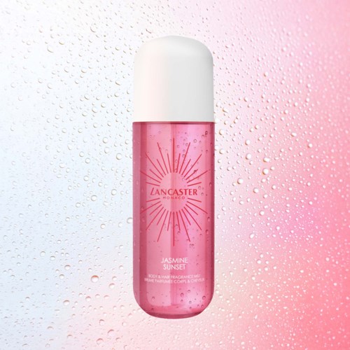 A pink body spray bottle with a white cap and sunburst design, related to Jasmine Sunset fragrance.