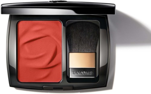 A makeup compact with red blush and a black brush with a gold band inside.