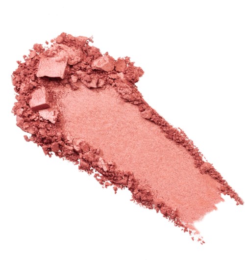 Ljust rosa pulver med några bitar, utbrett på vit bakgrund.