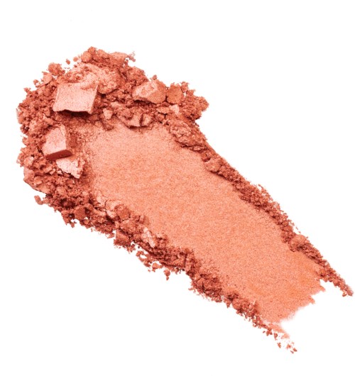 Ett rosa-orange pulver med små trasiga bitar ovanpå, sprider ut sig i en skara.