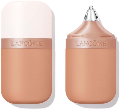A Lancôme concealer or highlighter stick with a nude-colored body and a clear cap.