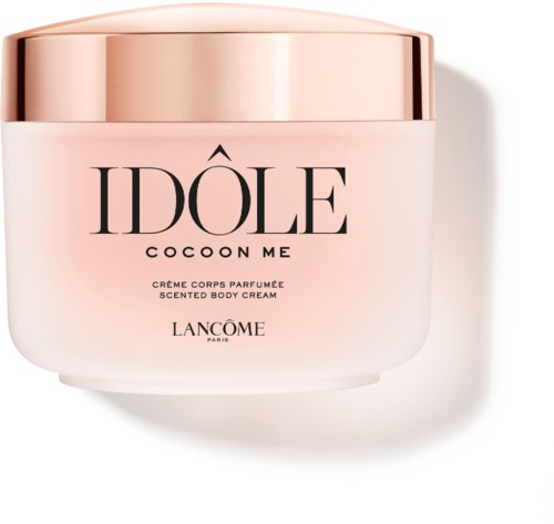 A scented body cream jar with a pink and gold design, labeled 'IDÔLE COCOON ME' by Lancôme.
