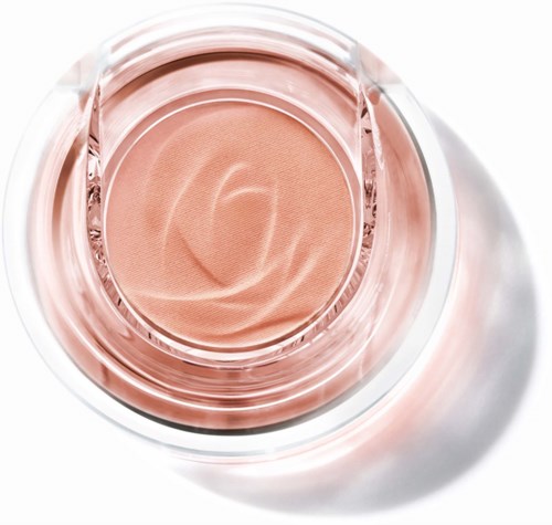 A round blush or foundation inside a clear, round container with a slightly swirled surface.