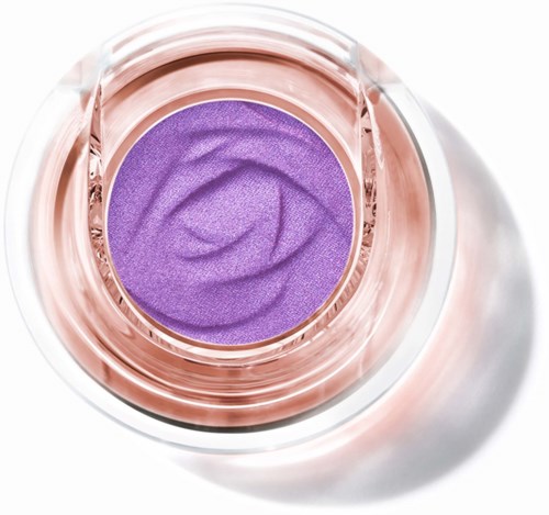 Purple eyeshadow inside a clear round container with a pinkish rim.