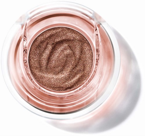 A close-up of a small jar with shimmery rose gold eyeshadow.