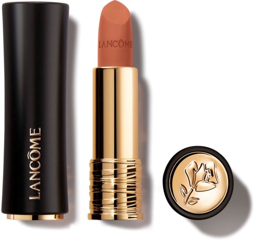 A Lancôme lipstick with a pinkish-brown shade, gold case, black top, and a circular lid with a floral design.