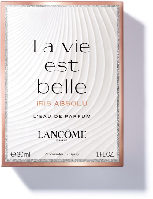 En parfymförpackning med elegant vit och rosa design, med text om en doft som heter Iris Absolu från Lancôme.
