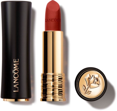 A red lipstick with gold case, black cap, and a circular gold emblem with a woman and a bell.