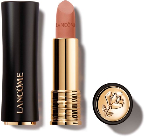 Een beige lippenstift met een gouden huls, zwarte dop en een losse ronde item met bloemlogo.