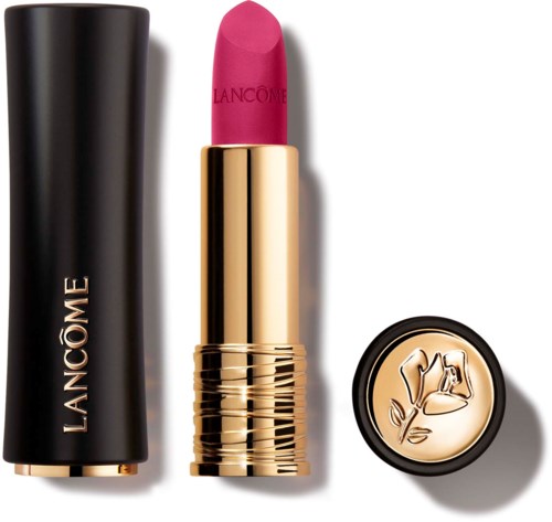 A pink lipstick in a gold tube, with a black case and a decorative lid with a flower design.