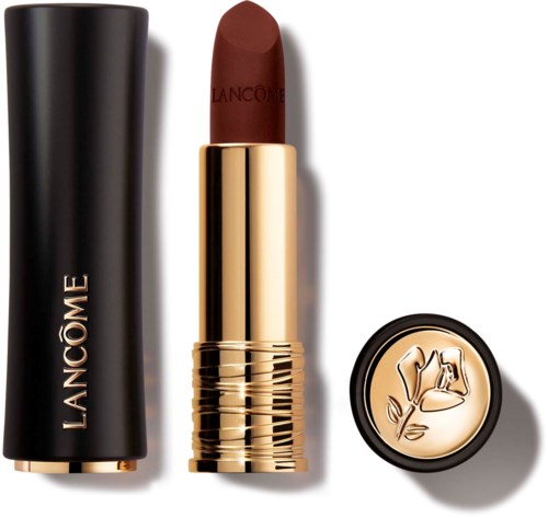 A brown lipstick in a gold tube, with a black cap and a round label showing a floral design.