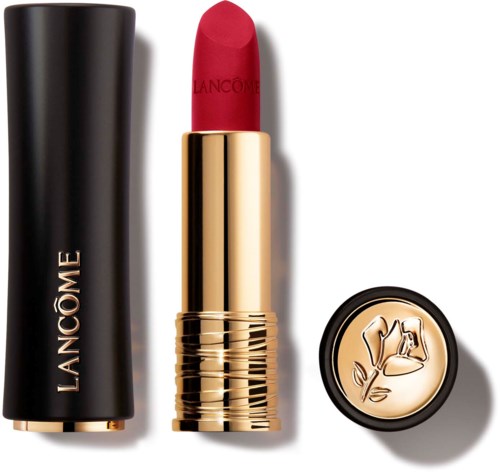 A red lipstick in a gold case, with a black cap and a decorative lid.