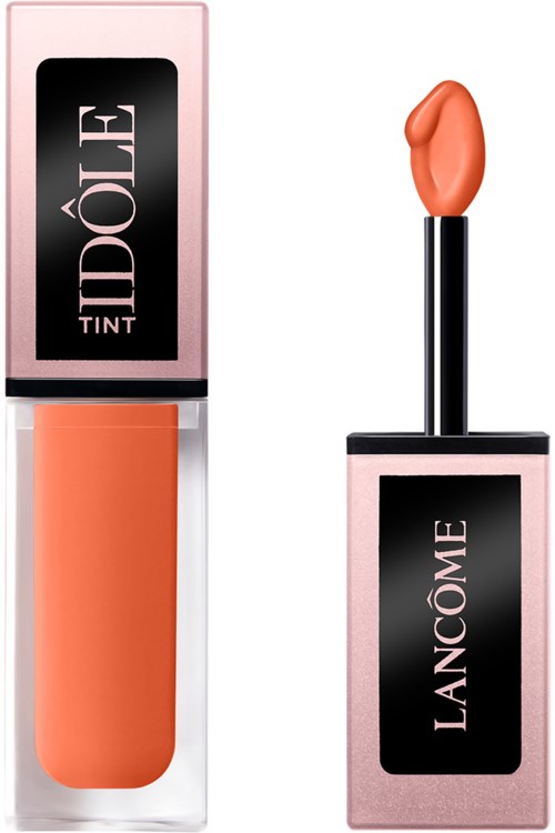 Lippenbalsem met perzikkleur in een roze en zwarte tube, met een zwart deksel.