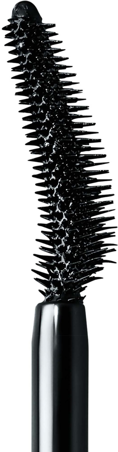 A black mascara wand with many tiny spikes, held upright on a silver handle.
