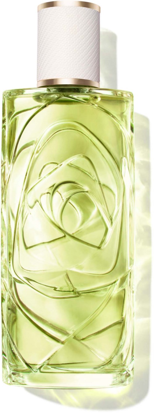 A tall glass perfume bottle with a white cap and a yellow-tinted liquid. The bottle has a rose design embedded inside.