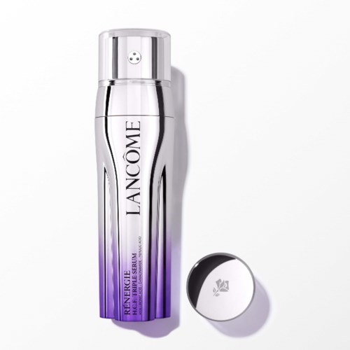 Een zilveren en paarse flesje van Lancôme huidverzorgingsproduct met deksel ernaast.