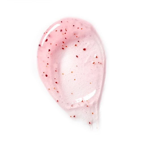 Ein rosa-weißer Löffel mit roten und orangenen Flecken, möglicherweise mit Dessert oder Essen.