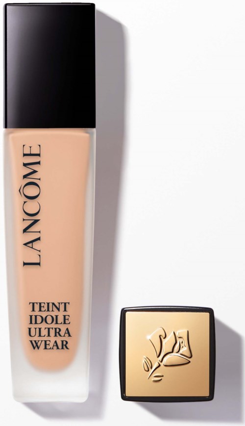 Lancôme foundation bottle with black cap, next to a small square gold compact with a rose logo.
