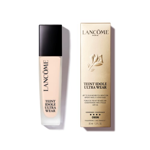 A bottle of Lancôme foundation and its box with a flower logo and product details in black and gold.