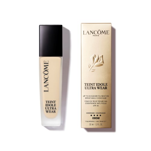 Een fles Lancôme Teint Idole Ultra Wear foundation met doos, beide crèmekleurig met zwarte en gouden tekst.