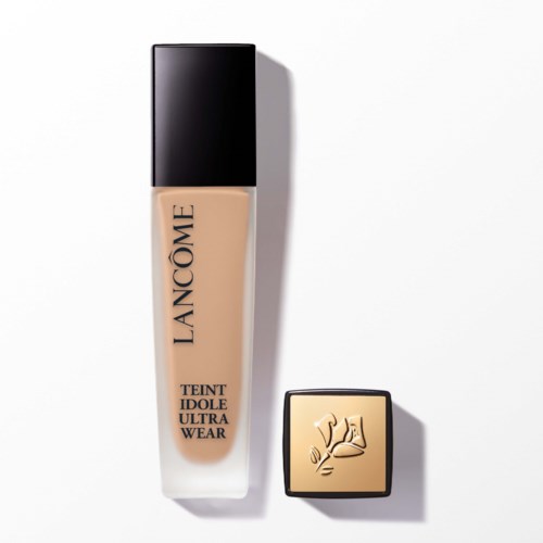 A bottle of Lancôme Teint Idole Ultra Wear foundation and a closed compact with a logo featuring a hand holding a flower.