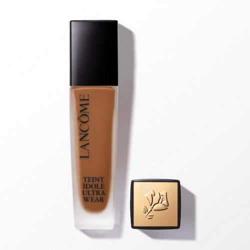 A foundation bottle labeled 'Lancôme Teint Idole Ultra Wear' and a small square makeup compact with a logo.