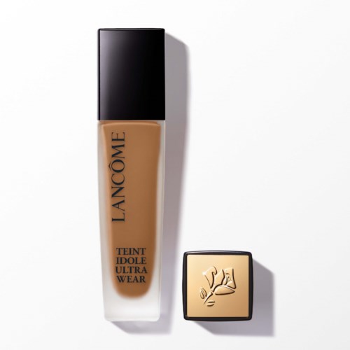 A bottle of Lancôme foundation with a black cap and a small beige compact with a hand-raising icon.