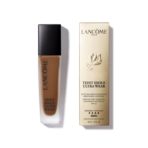 A bottle of Lancôme foundation and its matching box, both with elegant designs and text details.