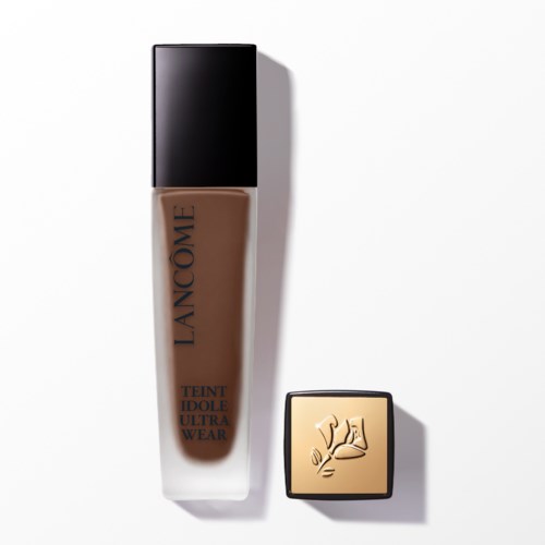 A bottle of foundation and a square compact with a hand and face design on a white background.