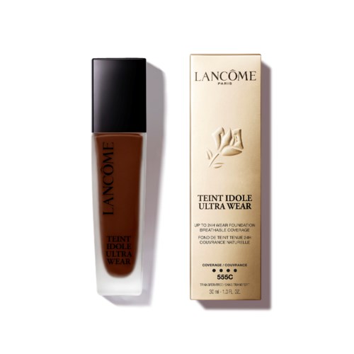 A bottle of Lanc?me foundation and its box in beige and black colors.