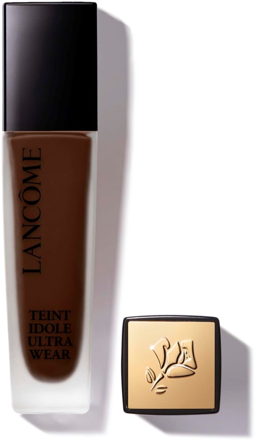 A bottle of liquid foundation with a black cap and a compact powder with a plant logo. Simple, minimal design.