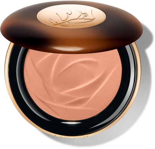 Gold compact with beige powder inside, open lid revealing the brand's logo on top.