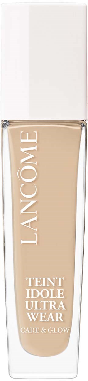 A tall, clear bottle of beige liquid foundation with a white cap, labeled 'LANCOME Teint Idole Ultra Wear' and 'Care & Glow.'