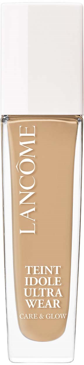 Een fles Lancôme Teint Idole Ultra Wear foundation met witte dop tegen een zwarte achtergrond.